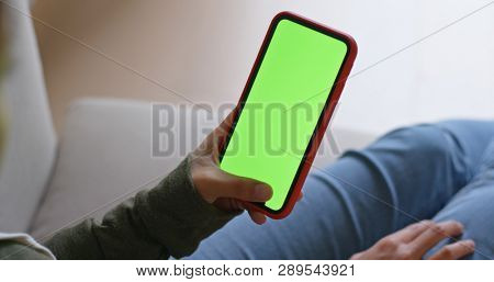 Woman hold with cellphone chroma key screen
