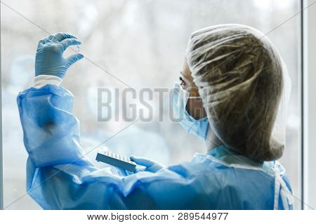 Scientist Doctor Examines The Chemical Results Of The Reaction After The Experiment On The Treatment
