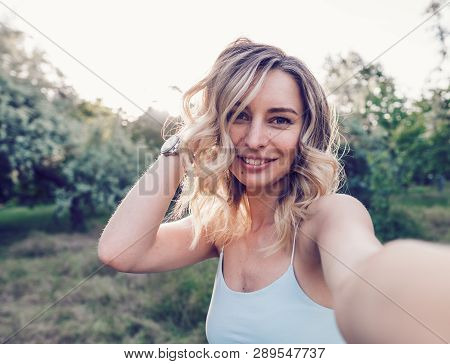 Stylish Modern Girl Taking A Selfie Out In The Park