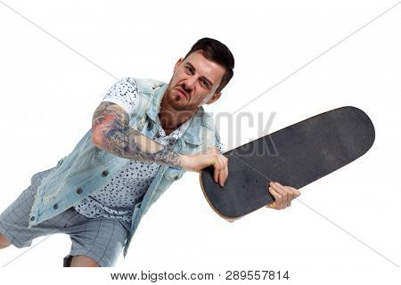 An angry tattooed man attacks. The guy swung to hit the skateboard. Isolated on white background. A collection of emotional people. unkind skater swung skate.