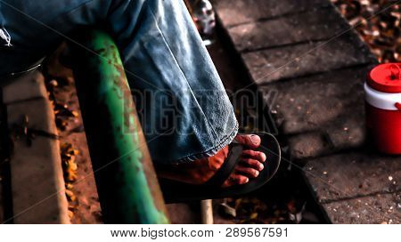 Feet With Signs Of Hard Work Wearing Plain Black Shoes For Relaxation