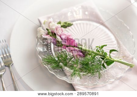 Closeup Table Setting With Plates And Tableware, Adorned With Flowers. Floral Decoration For Wedding
