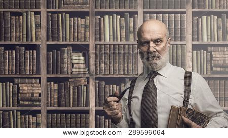 Professor Posing In The Library With Books