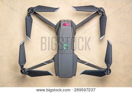 Fort Collins, CO, USA - March 10, 2019  Overhead view of the folding DJI Mavic 2 pro drone against textured handmade paper.