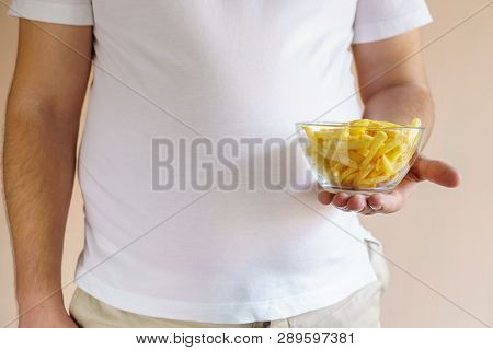 Processed Products, Fast Food, Unhealthy Diet, Imbalanced Ration. Overweight Man Eating Salted Fatte