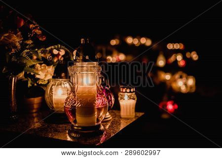 The Cemetery, Candles Burning In Lanterns At Night During All Saints Day, Bokeh Of Light Candle