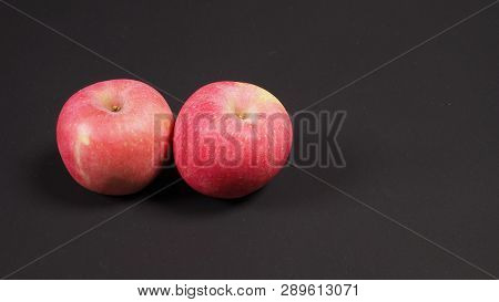 Pink Apple Or Ambrosia Apple On Black Background.