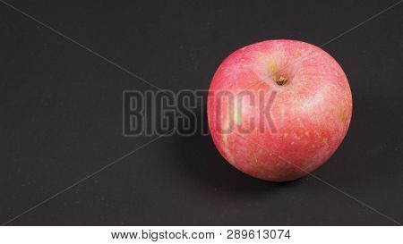 Pink Apple Or Ambrosia Apple On Black Background.