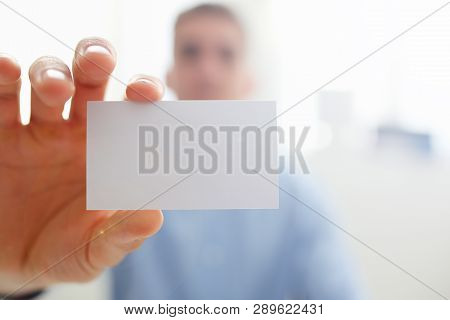 Smiling Business Man In Suit Hold In Hand Blank Calling Card Closeup. White Collar Partners Company 