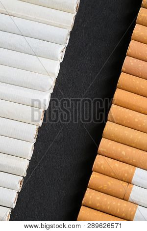 Place For Text Among Cigarettes And Tobacco, Black Background.