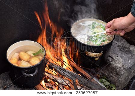 Cookinf Boiled Potatos And Soup From Green Onion On Bonfire At Camping