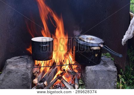 Cooking Soup On Campfire At Garden In Pan
