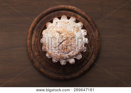 Easter Yeast Cake Sprinkled With Powdered Sugar On Wooden Table, Top View