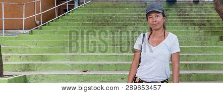 Asian Woman Standing In Front Of Green Stairs At Wat Tham Suea