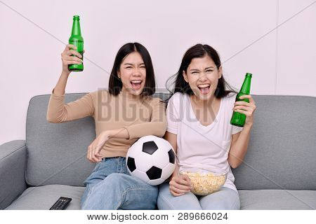 Concept Of Cheering. Asian Teenagers Watching Football On Television. People Are Cheering And Winnin