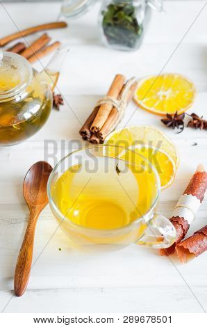Tea Pot With Hot Greent Tea, Cup Of  Tea  With Mint,  Lemon Slice, Dry Fruits Roll And Tea Mint Leav
