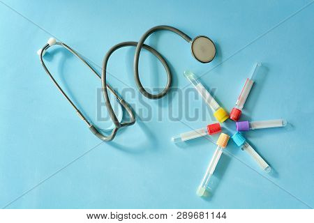 Phonendoscope Stethoscope, Different Colored Empty Vacuum Venipuncture Test Tubes On Blue Background