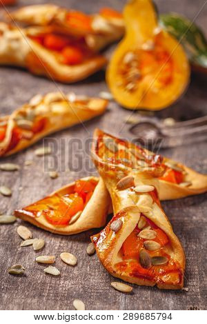 Small Biscuits With Pumpkin On Wooden Rustic Table. Close Up