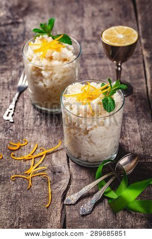 Two Glasses Of Rice Pudding On Wooden Rustic Table. Close Up