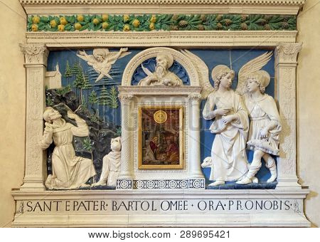 FLORENCE, ITALY - JANUARY 10, 2019: Nativity by Tuscan painter in the middle of Altar showing St. Bartholomew, Archangel Raphael and Tobias  by Andrea della Robbia, Basilica Santa Croce in Florence