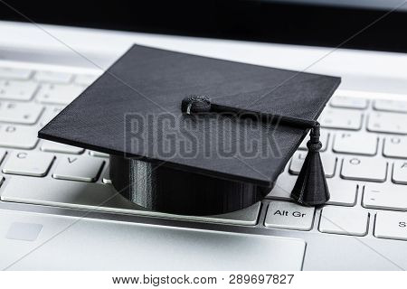 Close-up Of Black Graduation Hat On Laptop Keypad