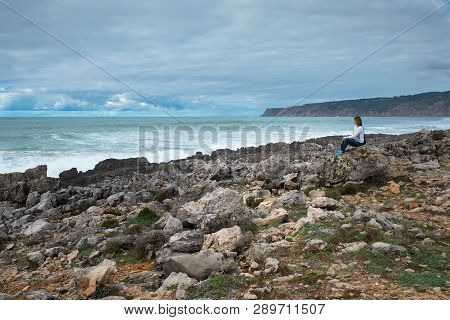 Woman, Girl Sitting On The Atlantic Ocean