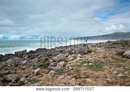 Woman, Girl Sitting On The Atlantic Ocean