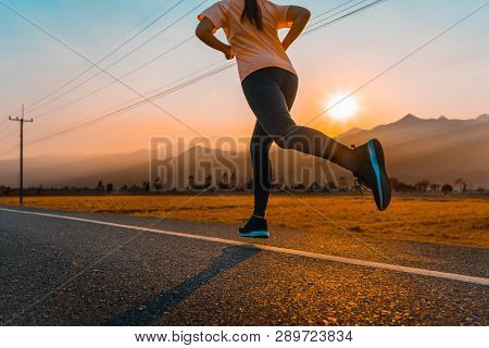 Young Asian Woman Enjoys Running Outside With Beautiful Summer Evening In The Countryside.