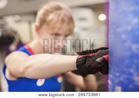 Closeup Shot Of Muscular Woman Learning To Beat With Fists Indoors. Practising Hits. Sparring .punch