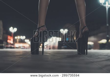 Female Feet Close-up. A Model Without A Face In Heels. High-heeled Shoes For Performing On Stage For