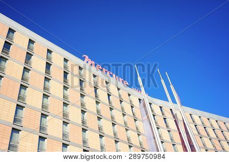Poznan, Poland - October 31, 2018: Top Of The Mercure Hotel Building With Flags In The Foreground.