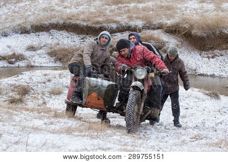Taraclia, Moldova - 23. 02. 2019: A Team On A Soviet Retro Motorcycle With A Sidecar In The Mud And 