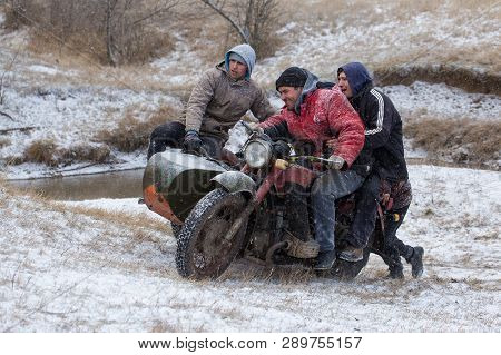 Taraclia, Moldova - 23. 02. 2019: A Team On A Soviet Retro Motorcycle With A Sidecar In The Mud And 