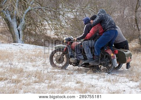 Taraclia, Moldova - 23. 02. 2019: A Team On A Soviet Retro Motorcycle With A Sidecar In The Mud And 