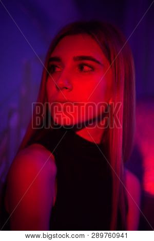 Sexy Young Beauty Woman Posing Over Night City Dramatic Red And Blue Neon Background