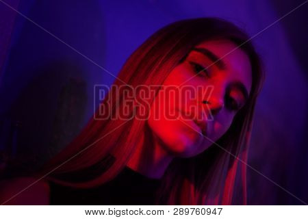 Sexy Young Beauty Woman Posing Over Night City Dramatic Red And Blue Neon Background