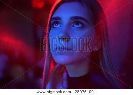Sexy Young Beauty Woman Posing Over Night City Dramatic Red And Blue Neon Background