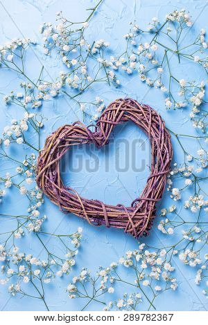 Big Decorative Heart And Pattern From Fresh White Gypsofila  Flowers On Blue Textured Background. To