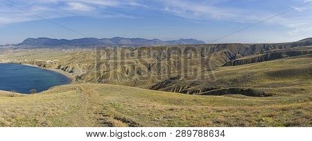 Clay Hills And Ravines As A Result Of Soil Erosion. The Foot Of Cape Meganom, Crimea. Sunny Day In E