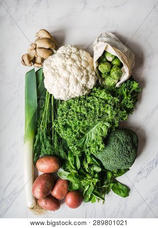 Healthy Vegan Ingredients For Cooking. Various Clean Vegetables And Herbs On Marble Background. Prod