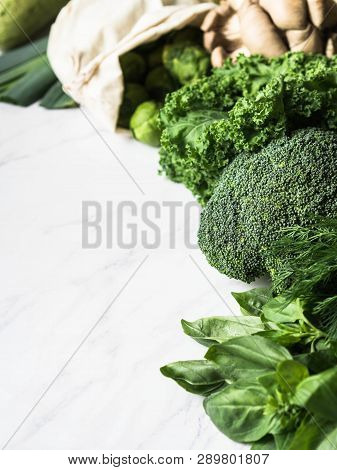 Healthy Green Vegan Ingredients For Cooking. Various Clean Green Vegetables And Herbs On Marble Back