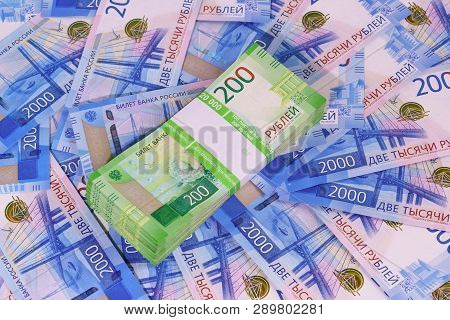New Russian Money: A Pack Of Two-ruble Banknotes In A Bank Package On The Background Of Two Thousand
