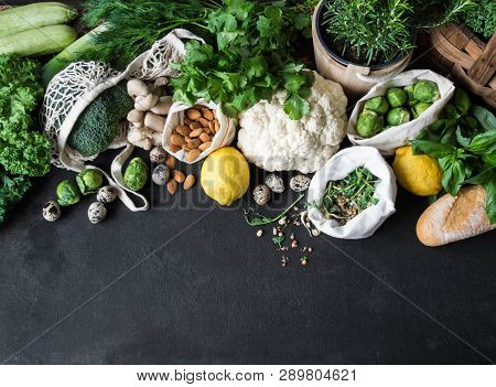 Healthy Vegetarian Ingredients For Cooking. Various Clean Vegetables, Herbs, Nut And Bread On Black 