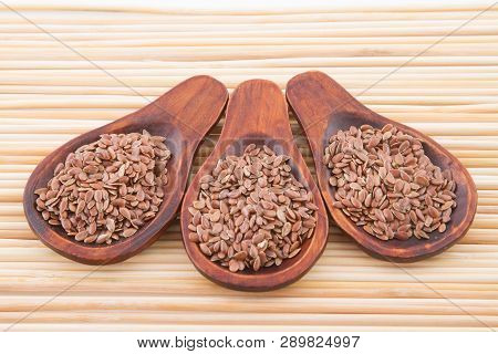 Flaxseed Grains In Wooden Spoon, Close Up