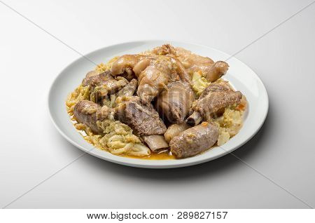 White Plate With Pork Meat And Savoy Cabbage
