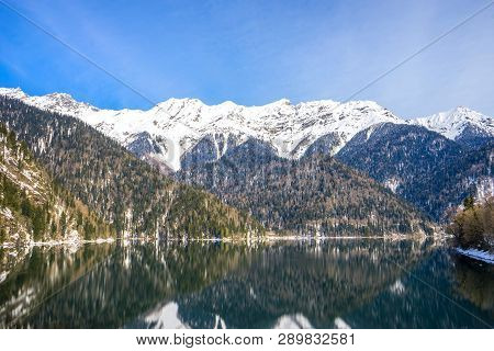 Beautiful Mountain Lake In The Spring. Snow Covered Mountains In The Background.