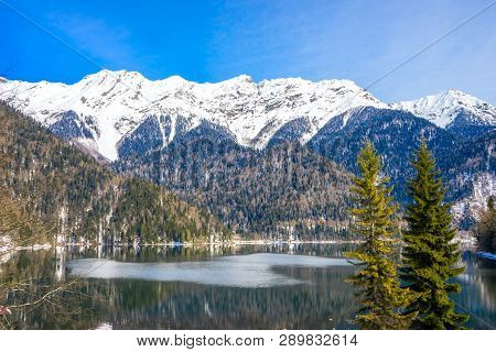 Mountains Covered With Snow On The Shore Of A Beautiful Lake
