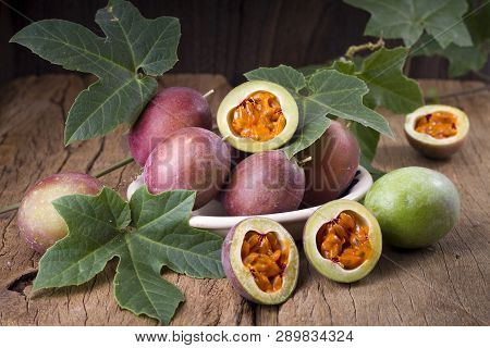 Fruits Of Gulupa On Vine Wood Table, Passiflora Pinnatistipula