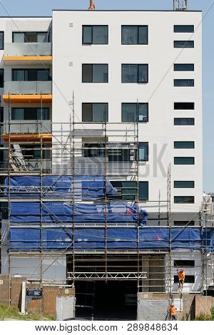 Gosford, New South Wales, Australia - March 4, 2019: Disassembling Scaffolding And Removing Safety N