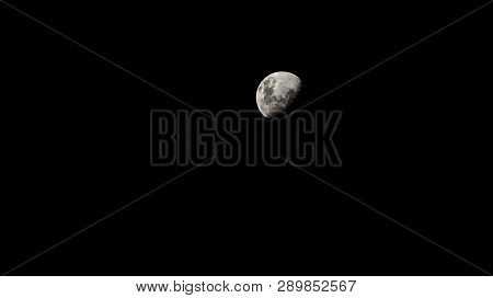 Only Half Of The White Moon Floats In The Black Sky.